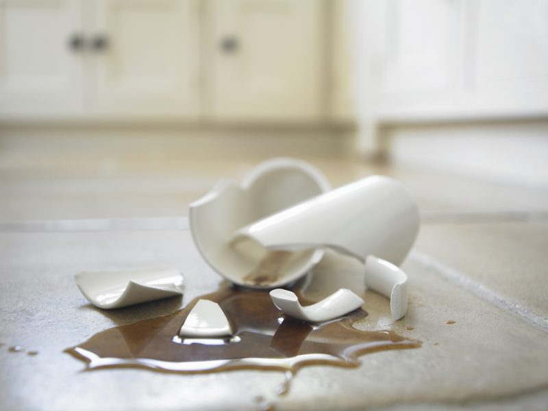 Close up of broken coffee mug and spilled coffee
