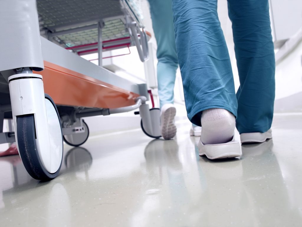 sudok1141000130.jpg - medical staff moving patient through hospital corridor