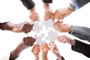andreypopov130801376.jpg - close-up photo of businesspeople holding jigsaw puzzle