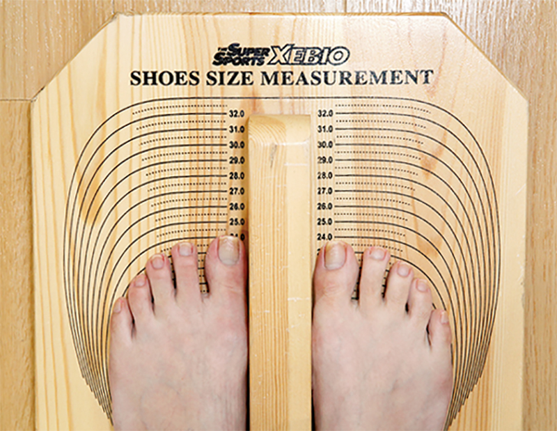足のサイズを測定している