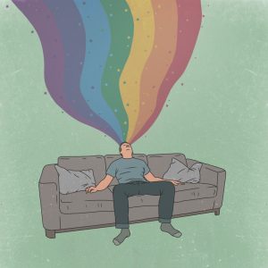 ソファーに座っている男性に虹色が吸い込まれている