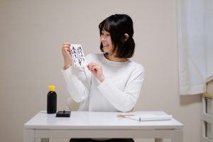 Woman showing letter written by Japanese calligraphy