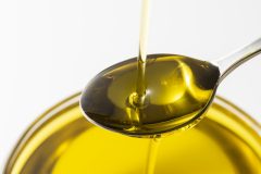 Scoop olive oil with a spoon
