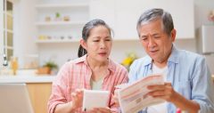 close up asian elderly couple calculate their receipt and bill with calculator look laptop about their financial statement feeling worried in living room at home - retirement concept