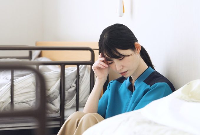 Asian caregiver tired from care work